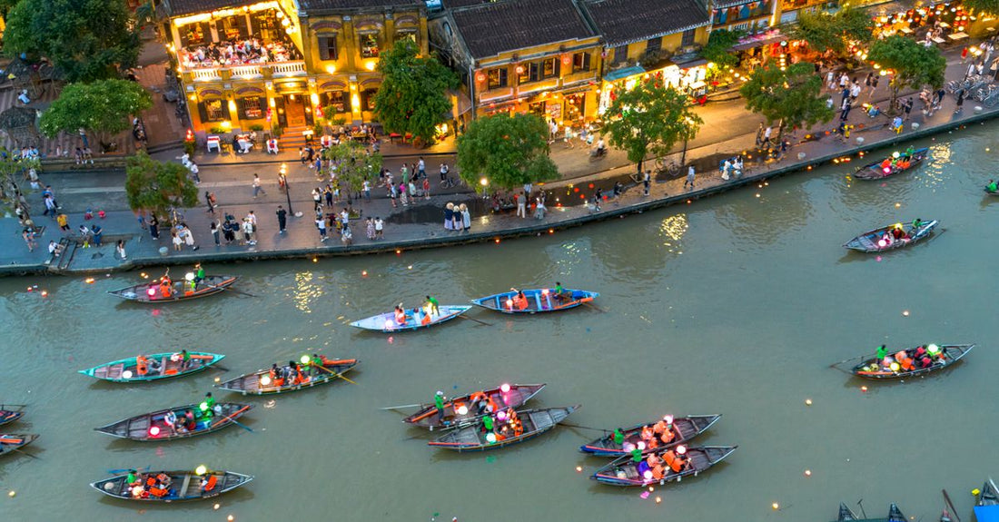 Aerial view of Hoi An's lantern-lit boat festival on the Thu Bon River at night, Vietnam